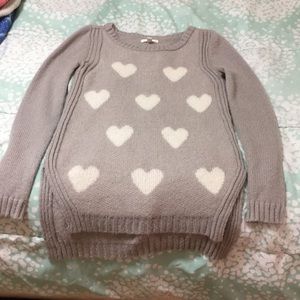 A cream/grey cozy sweater with hearts